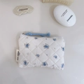 Close-up of quilted floral cotton pouch with blue zipper pull and simple wish label - Light Blue Floral on White