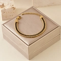 Close-up of golden titanium steel double-layer chain bracelet with black zircon inlay - Black