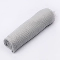 Macro detail of grey crinkle cotton linen scarf showing textured gauze and raw fringe edges - Light Gray