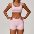 Pink sports set featuring a U-neck sports bra and cross-waist gym shorts for women - S / Top And Bottom / Bra + Shorts / Peach Pink