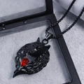 Close-up of black wolf head pendant with red teardrop crystal in a jewelry box - Black Wolf Head Red Gem