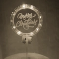 Close-up of LED glowing acrylic cake topper with Merry Christmas engraving and battery box - Style 7 Warm Light