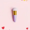 Detail view of angled teardrop makeup sponge brush with gold ferrule and purple handle - Single Pack / Gold Tube + Purple Mushroom Head