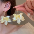 Macro detail of creamy resin flower earrings with pearly finish on a model's ear - Light Yellow 3D Floral Large Hoop (167# Silver Earring Post - Yellow)