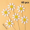60 pieces of daisy cake toppers with smiling faces on a soft yellow background - Sunflower Topper 60 Pcs