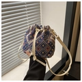 Detail of woven bucket bag featuring blue geometric patterns and white leather drawstring - Style 1