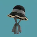 Detailed close-up of a woven straw bucket hat featuring a chic gingham bow and ribbon - M (56-58cm) / Gingham Ribbon Style / Black