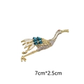 Exquise gouden kraanvogelbroche met wit email, blauwe kristallen en fonkelende strassteentjes - Kraanvogelontwerp