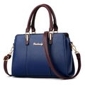 Blue faux leather handbag with burgundy handles and gold hardware in trapezoid shape - Blue