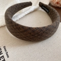 Detail showing deep brown tweed fabric headband with handmade woven label on canvas - Gray and Coffee Patchwork