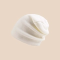 Detailed close-up showing the fine knit texture and soft fabric of the white winter beanie - Milky White