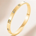 Minimalist gold stainless steel bangle with screw motifs and four sparkling cubic zirconia - Gold Bangle (KJ)