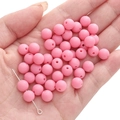 Pink matte acrylic round beads for DIY jewelry held in hand with metal pin tool - Watermelon red