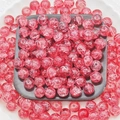 Macro shot of 10mm red glass beads with gold wire silk thread and cracked ice pattern - Imperial Red