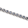 Detailed macro of stainless steel chain links with embedded faceted dark blue beads - Blue 8mm