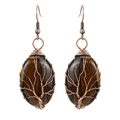 Macro shot of handmade wire-wrapped tree of life earrings with tiger eye stones - Antique Copper + Tiger's Eye