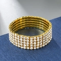 Macro shot of 5-row crystal stretch bracelet with sparkling rhinestones on gold base - 5 Rows / Gold