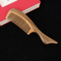 Natural sandalwood hair comb with large ergonomic handle on a black velvet background - Style 11/Length 20cm