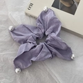 Detail of purple fabric scrunchie with corner pearls on a minimalist background - Light Purple