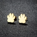 Minimalist golden stainless steel paw print stud earrings on a sleek black background - 104 Paw / Gold