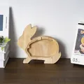 Detail of bunny-shaped wooden money bank with transparent acrylic panel and metal screws - Rabbit