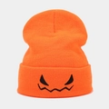 Detail of orange knit beanie with black pumpkin devil face embroidery on the folded cuff - M (56-58cm) / Orange