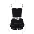 Detail of black strapless crop top with pink bow and ruffled tiered mini skirt - S / Black