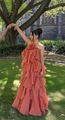 Detail of a brick orange maxi dress featuring layered ruffles and 3D floral accent - S / Maxi Skirt / Orange
