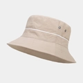 Detail showing metallic ventilation eyelets and white contrast piping on khaki bucket hat - One Size / Camel