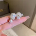 Close-up of elegant double-sided pearl earrings with gold accents and pave-set seed pearls - Double Pearl Cap Design (Silver Pin)