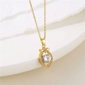 Macro detail of gold bow necklace with heart pendant and sparkling zircon inlay - Gold