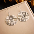Macro shot of silver spiral hollow earrings with fishhook clasp on leather texture - Spiral Hollow Disc Hook Style (E5784 Steel Color)