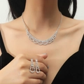 Silver waterdrop pendant necklace and earrings set with crystal rhinestones on a model - Hollow Pattern Rhinestone Set (DTN14026783S)