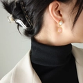 Elegant pink rectangular gemstone earrings with white pearl and gold finish on model - Gold