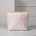 Close-up of floral quilted drawstring pouch with intricate diamond stitching and cotton fabric - New Pink Floral