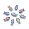 Detailed view of nine rainbow-plated metal fish pendants arranged for DIY jewelry making - Multicolor