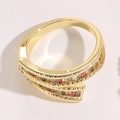 Macro detail of gold-plated wrap ring featuring multi-colored square-cut zircon stones - Cross Zirconia Style