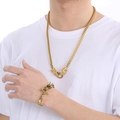 Detailed close-up of golden stainless steel dragon bone necklace and bracelet set on model - Style 1 Gold / Bracelet 22cm