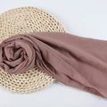 Dusty pink chiffon hijab shawl with delicate rolled edges on a woven straw mat - 88