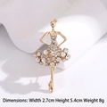 Golden ballerina brooch with sparkling crystals on white geometric props - Ballet Dancer