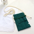 Detail view of dark green knitted phone bag with cream-colored shoulder strap - One Size / Lake Blue Bag + Cream Rope