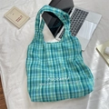 Blue and green checkered canvas tote bag with embroidered logo on a white bed background - Blue Green Grid