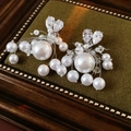 Detail of elegant silver needle pearl earrings with heart tassels and sparkling zircons - Silver