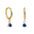 Close-up of gold hoop earrings with round blue zircon pendants in prong setting - Blue