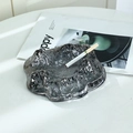 Modern dark gray iceberg glass ashtray with unique mountain texture on a white desk - Black and Gray