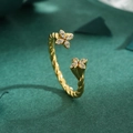Elegant gold clover open ring with sparkling cubic zirconia on a green background - Adjustable Open / Gold