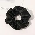 Close-up of a premium black silk scrunchie with elegant satin texture and elastic band - Black