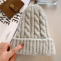 Macro shot of thick cable knit texture on grey winter beanie with lifestyle props - M (56-58cm) / Light Gray