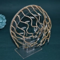 Close-up of golden bridal headband with sparkling rhinestones and marquise crystal details - A491 / Gold