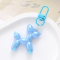 Detail of blue iridescent balloon dog charm with metallic lobster clasp on display - Blue